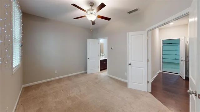 an empty room with fan and entrance