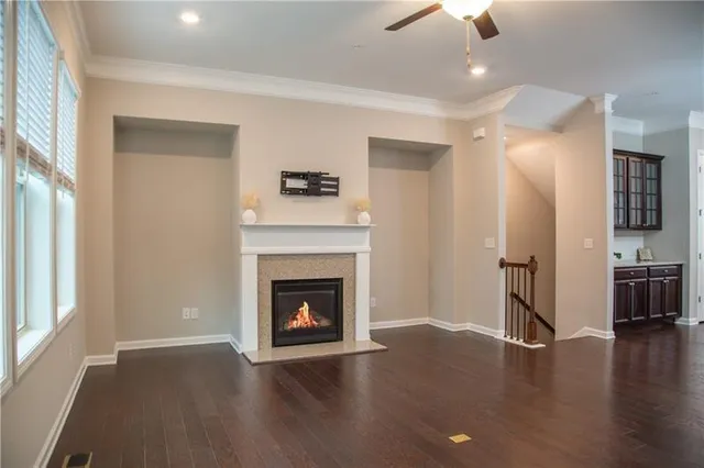 a living room with wooden floor and a fireplace