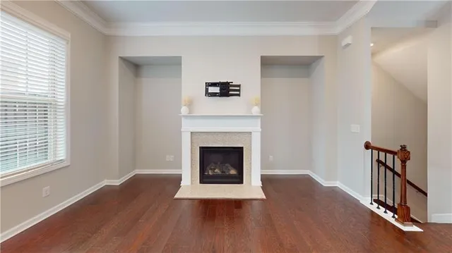 a living room with wooden floors and a fireplace