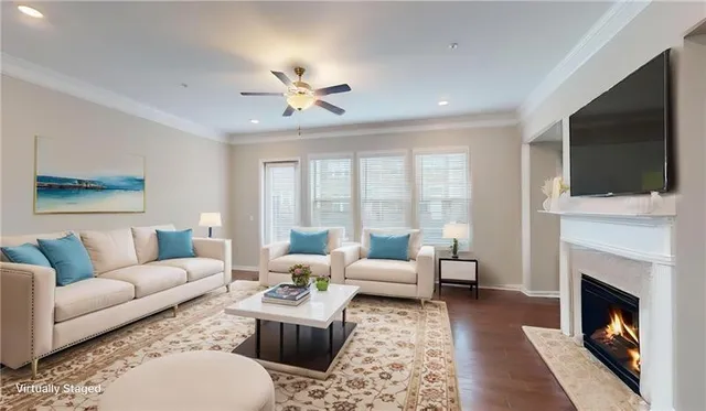 a living room with furniture a fireplace and a flat screen tv