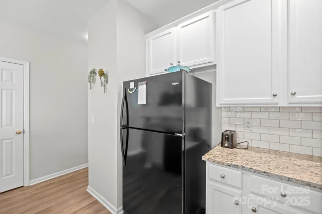 a kitchen with a refrigerator and a sink