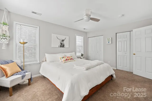 a bedroom with a bed a couch and a window