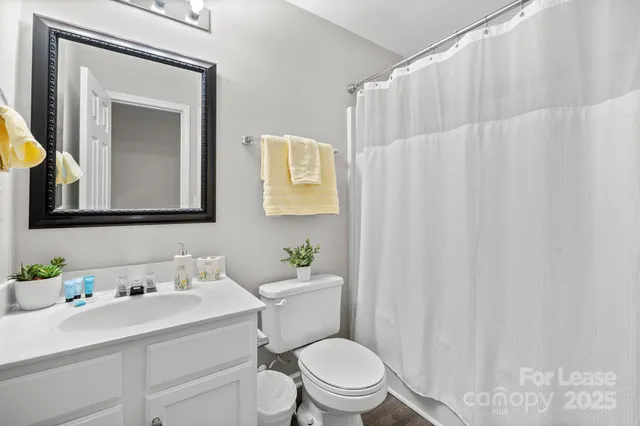 a white toilet sitting next to a bathroom sink