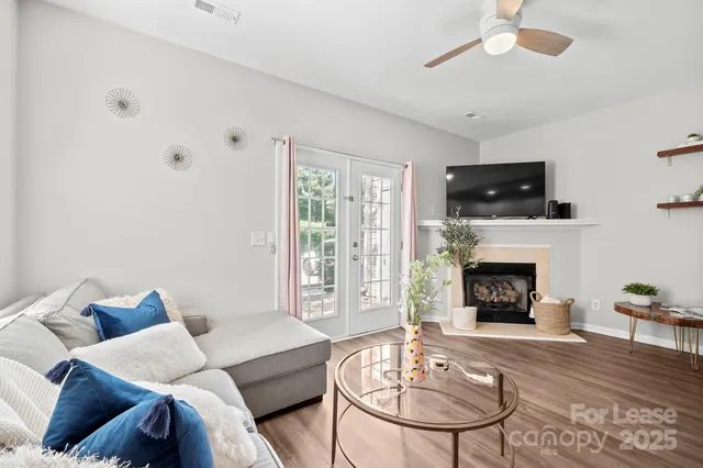 a living room with furniture a fireplace and a flat screen tv