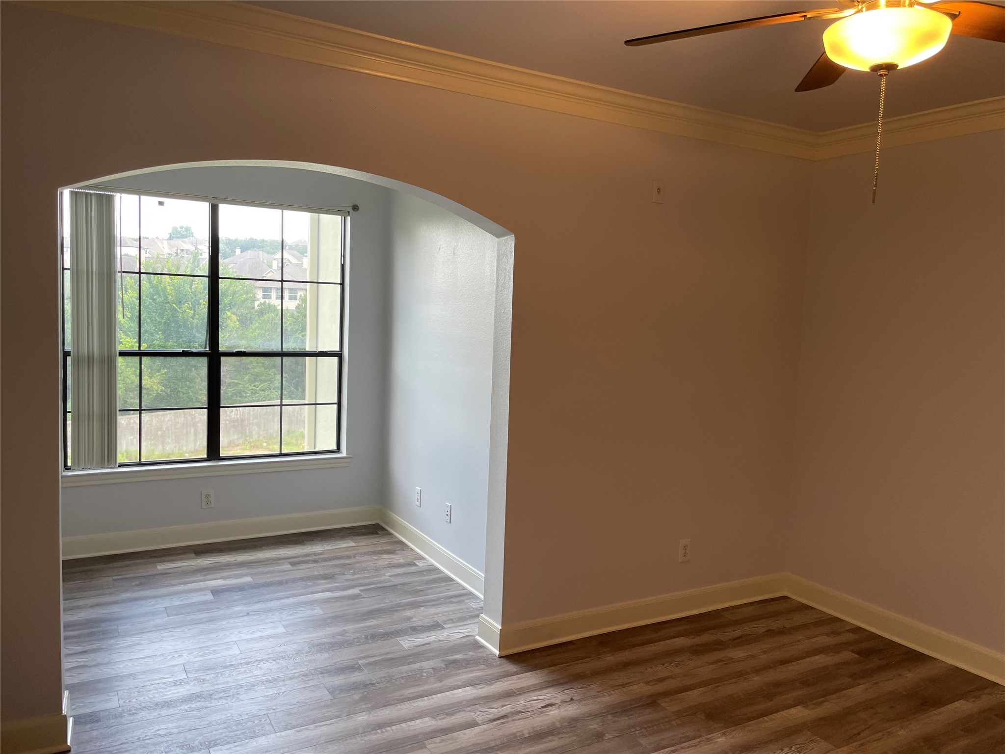 7701 Rialto Boulevard, Unit 822 Austin, TX 78735 - Photo 11 of 22 an empty room with wooden floor and windows
