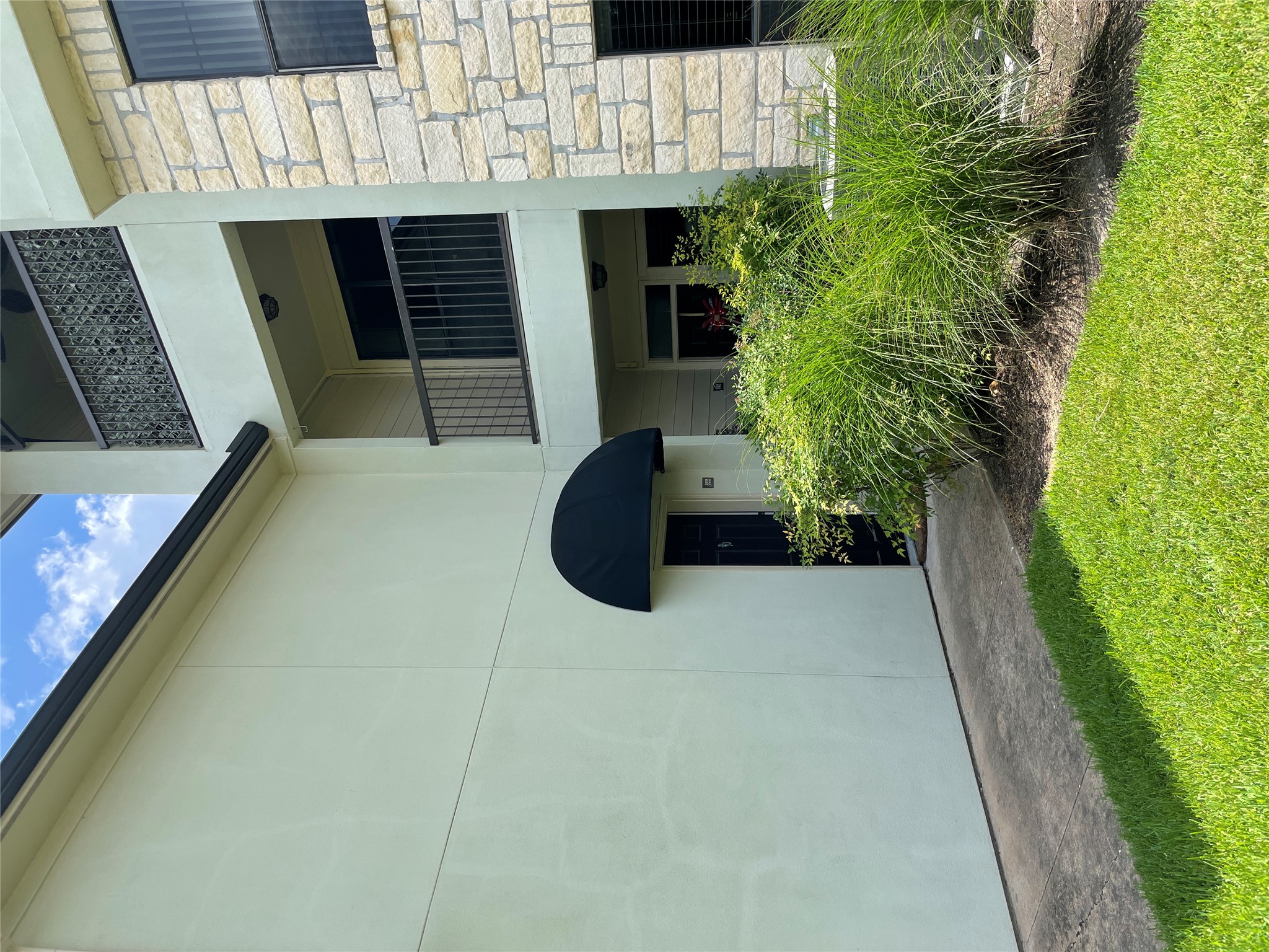 7701 Rialto Boulevard, Unit 822 Austin, TX 78735 - Photo 3 of 22 a front view of a house with plants and garden
