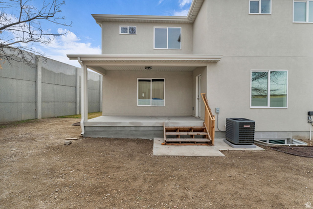576 7th Avenue Midvale, UT 84047 - Photo 30 of 32 Rear view of property featuring stucco siding and a patio