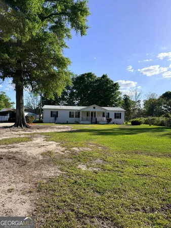 a swimming pool with outdoor seating and yard