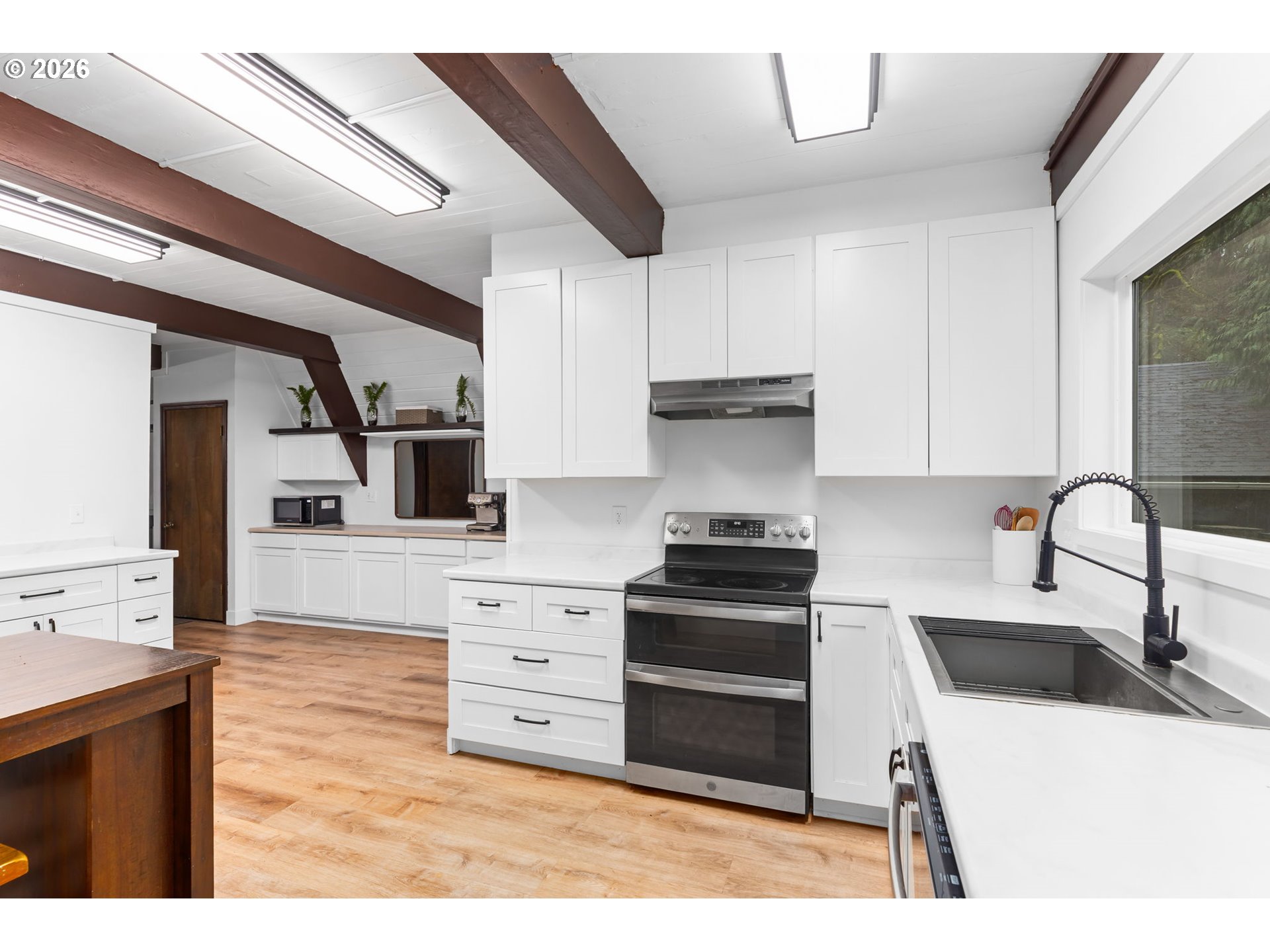 34221 Southeast Colorado Road Sandy, OR 97055 - Photo 21 of 48 a kitchen with stainless steel appliances kitchen island granite countertop a sink and cabinets