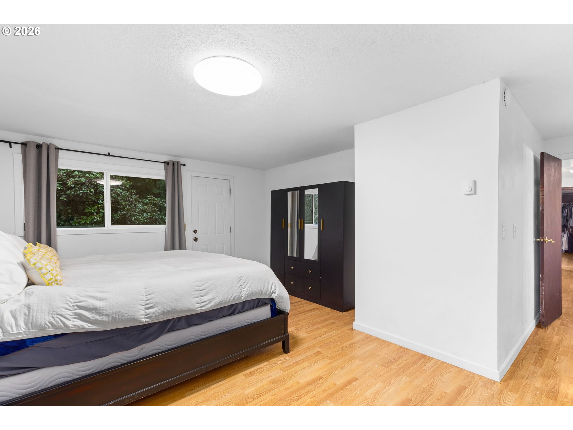 34221 Southeast Colorado Road Sandy, OR 97055 - Photo 25 of 48 a bedroom with a bed and wooden floor