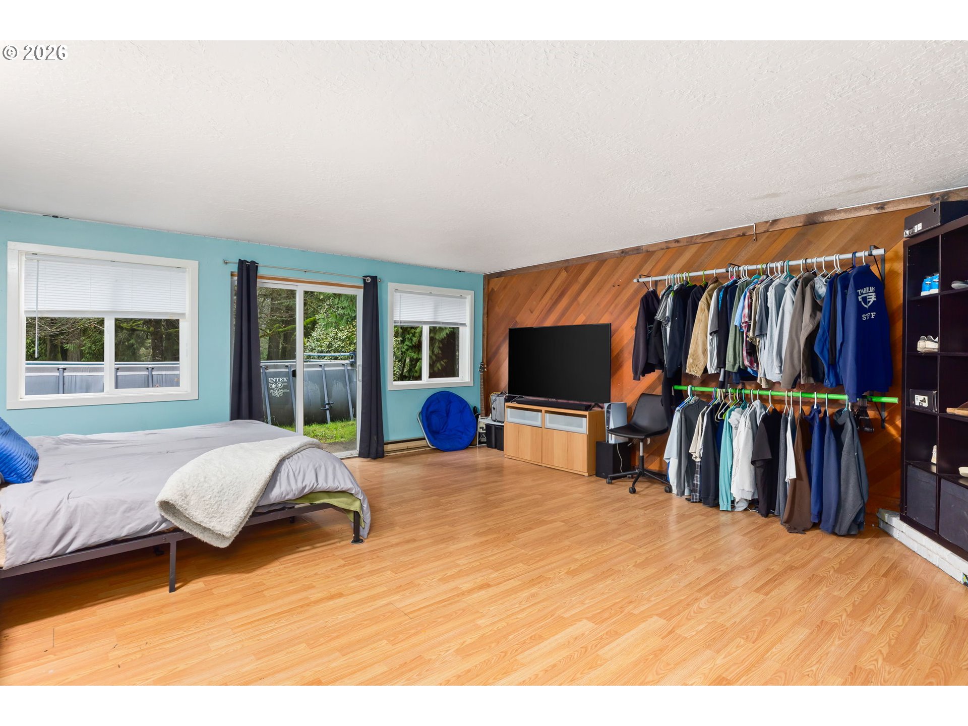 34221 Southeast Colorado Road Sandy, OR 97055 - Photo 27 of 48 a bedroom with a bed and a flat tv screen next to a window