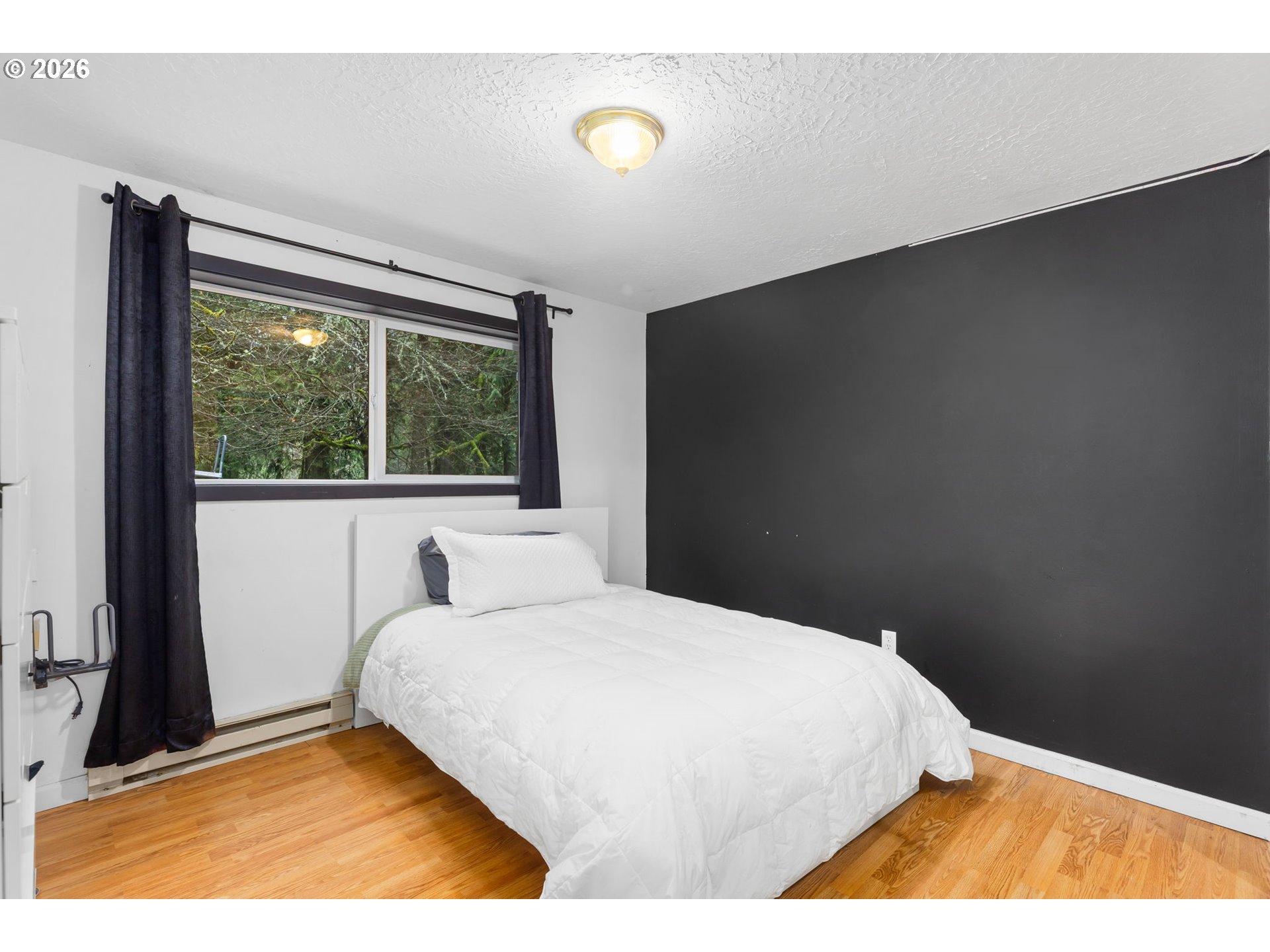 34221 Southeast Colorado Road Sandy, OR 97055 - Photo 28 of 48 a bedroom with a bed and a night stand