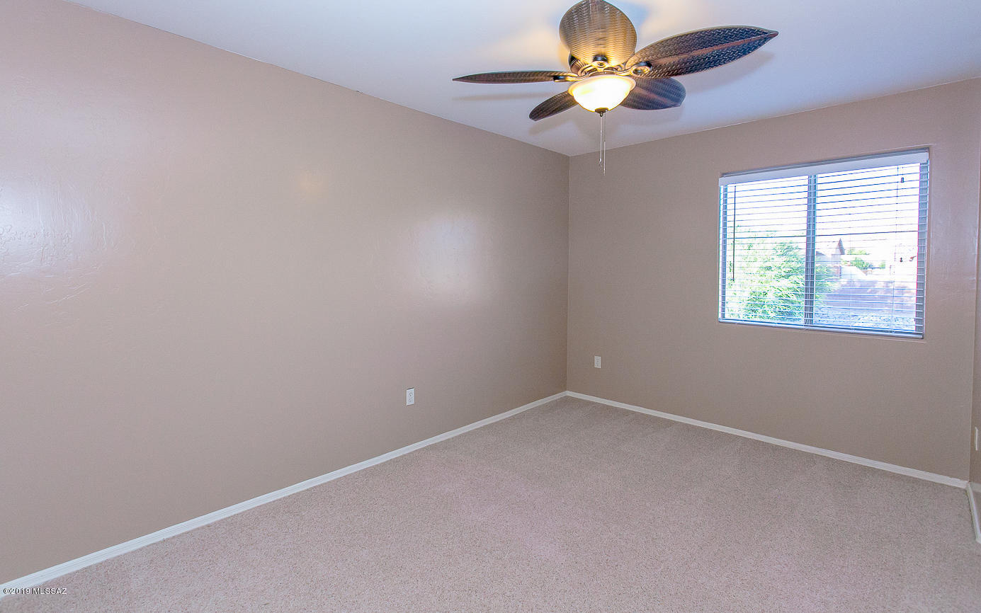39103 Winners Circle Tucson, AZ 85739 - Photo 11 of 19 an empty room with a window and a fan