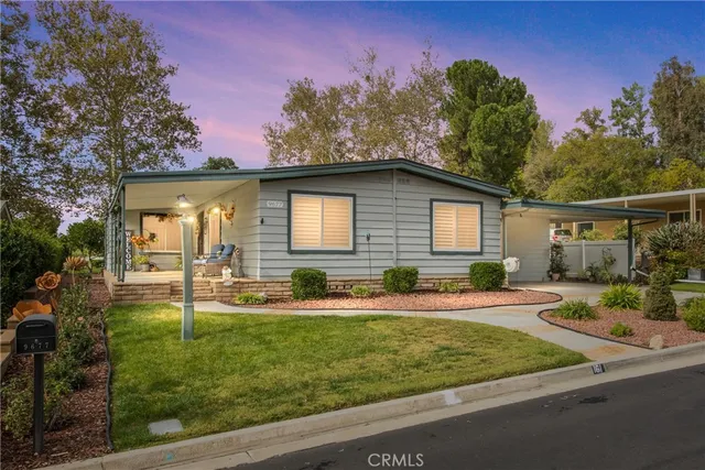 a view of a house with backyard and sitting area