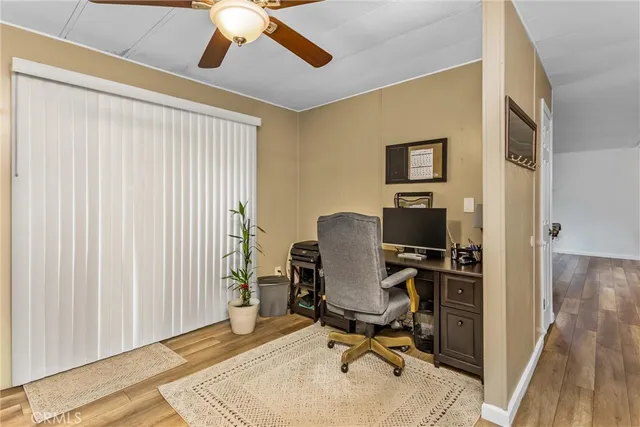 a view of a workspace with furniture and a window