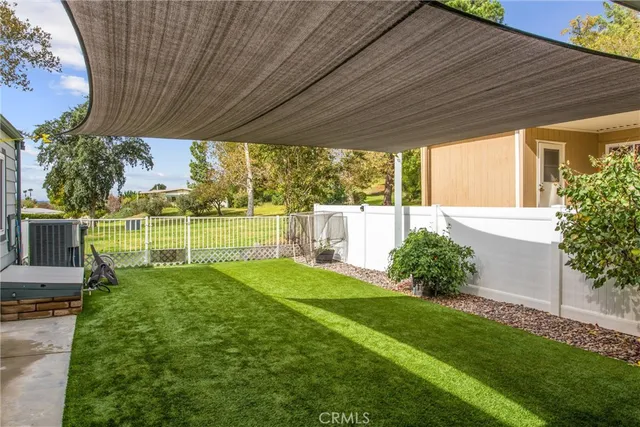 a view of a house with backyard and a garden