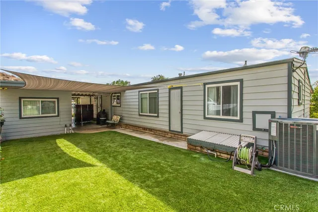 a view of a house with a backyard