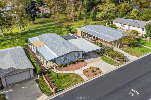 an aerial view of a house with garden space and street view