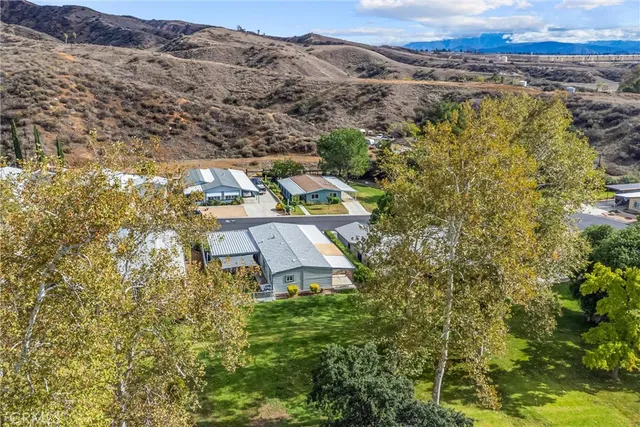 a view of a houses with a lush green hillside