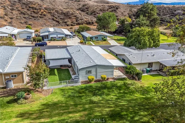 an aerial view of multiple houses with yard