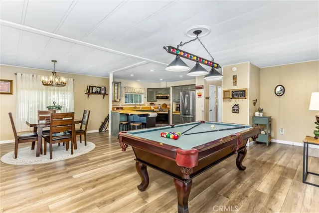 a room with pool table and windows