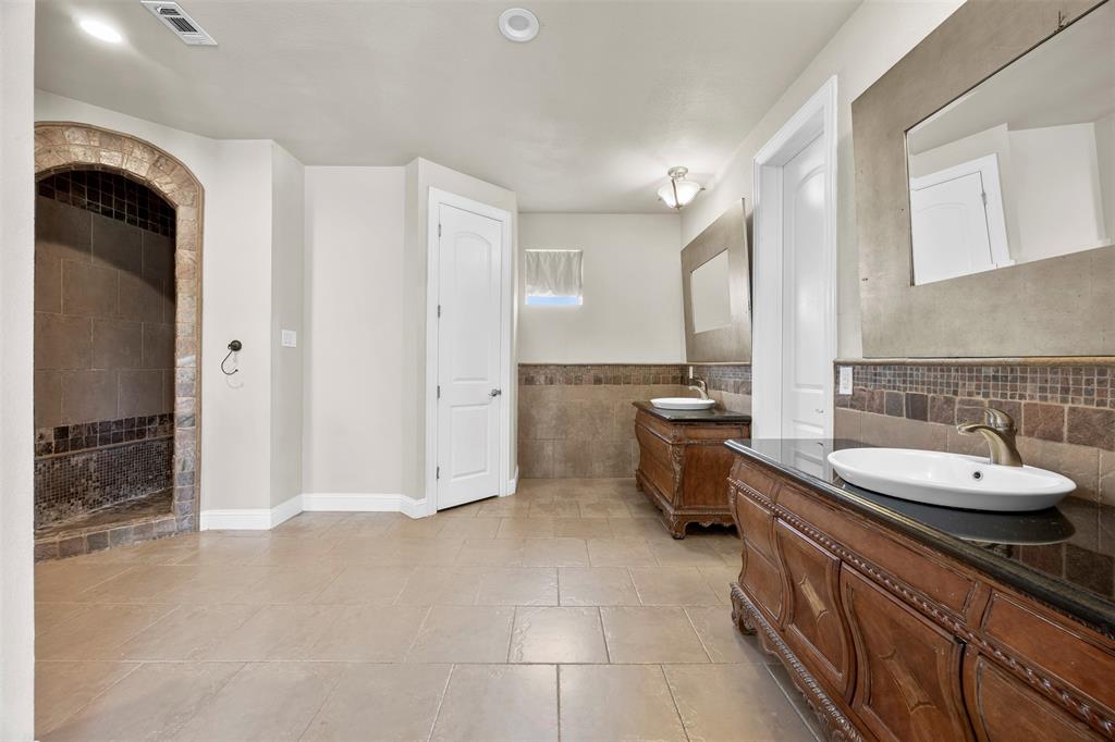219 Mohundro Road Ferris, TX 75125 - Photo 21 of 40 a spacious bathroom with a sink double vanity and a mirror