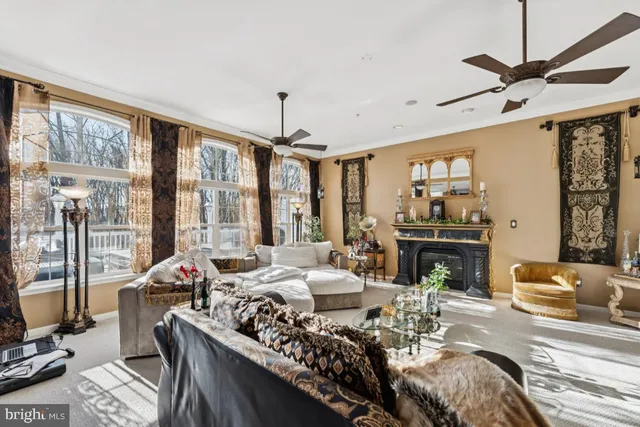 a living room with furniture large window and flat screen tv