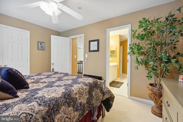 a bedroom with a bed and a potted plant