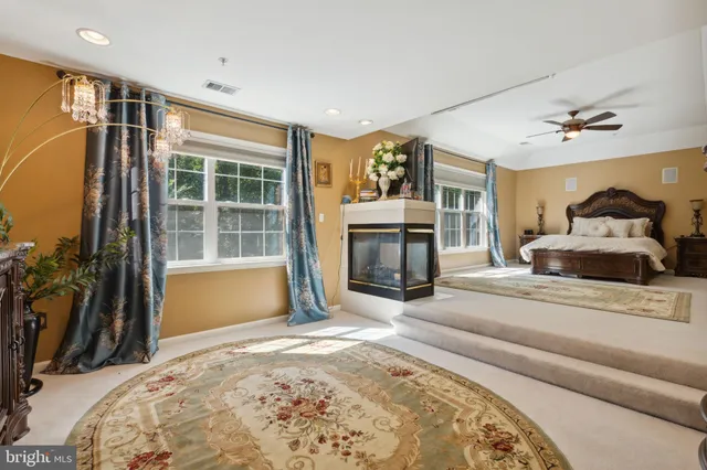 a spacious bedroom with a bed and a fireplace