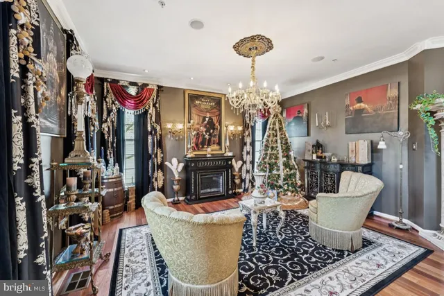 a living room with furniture and a chandelier
