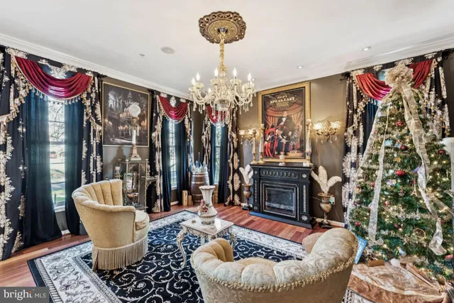 a living room with patio furniture and a chandelier