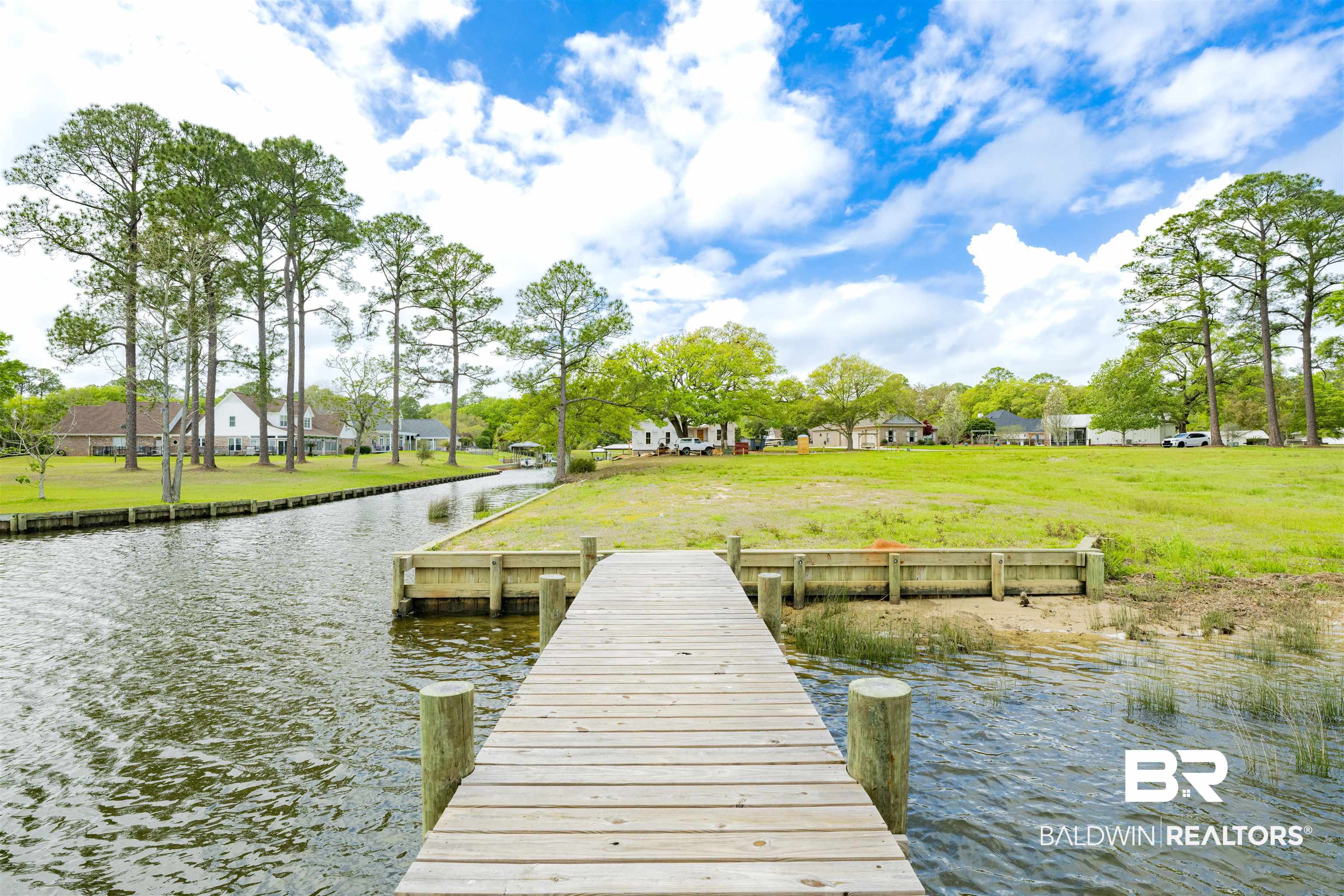 0 South Windsor Road South Theodore, AL 36582 - Photo 4 of 22 Dock with a water view, a lawn, and a residential view