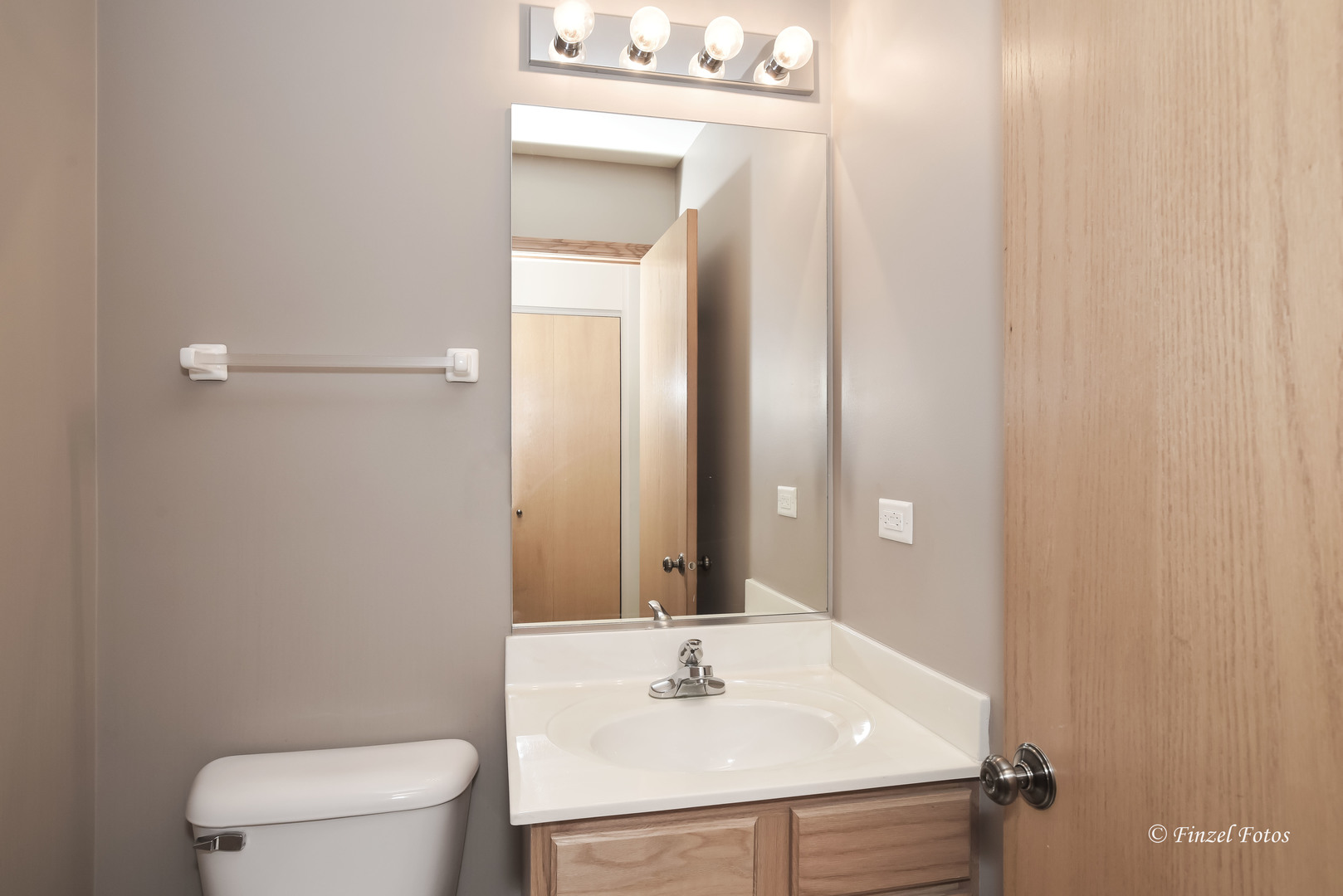 1931 South Cedar Lake Road Round Lake, IL 60073 - Photo 8 of 16 a bathroom with a sink vanity mirror and toilet