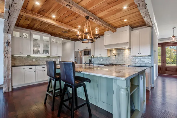 a kitchen with stainless steel appliances granite countertop a refrigerator and cabinets