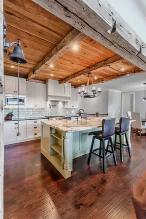 a kitchen with stainless steel appliances granite countertop a stove and a wooden floors