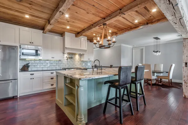 a kitchen with stainless steel appliances granite countertop a stove and a refrigerator