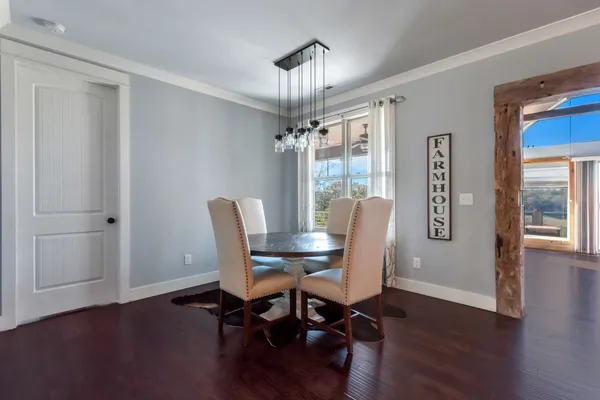 a living room with furniture a fireplace and large windows