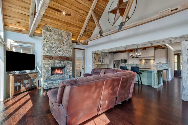 a bedroom with a large bed and wooden floor