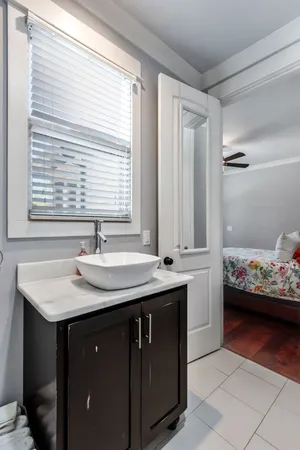 a bathroom with a sink toilet vanity and bathtub