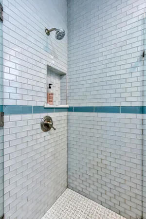 a bathroom with a sink a toilet a mirror and bathtub