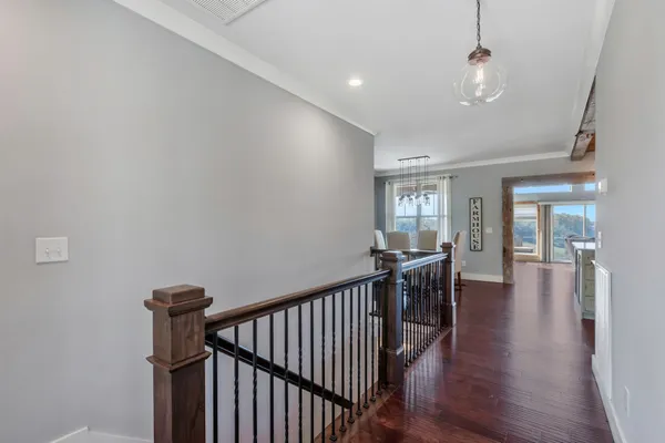 a kitchen with stainless steel appliances granite countertop a table chairs sink and cabinets