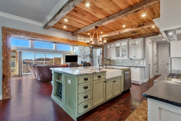 a kitchen with a table chairs and wooden floor
