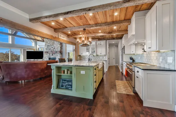 a kitchen with stainless steel appliances granite countertop a table chairs stove a sink and dishwasher