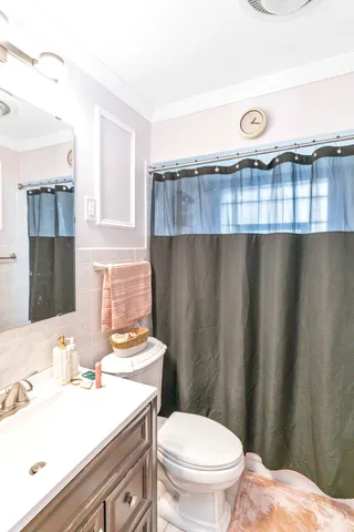 a bathroom with a sink a toilet a mirror and vanity