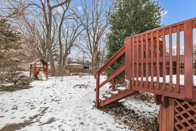 a view of a wooden fence with a tree