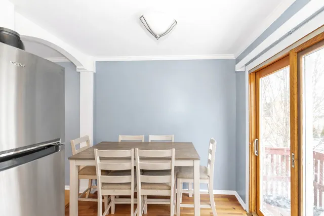 a view of a bedroom with a window and a ceiling fan