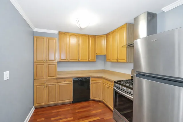 a kitchen with stainless steel appliances granite countertop a refrigerator and a sink