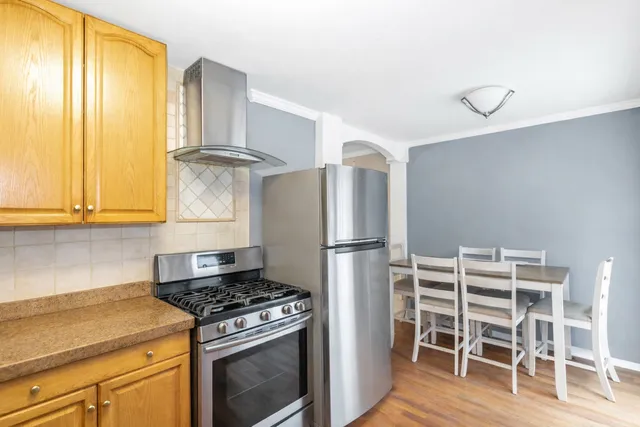 a kitchen with wooden cabinets and a stove top oven