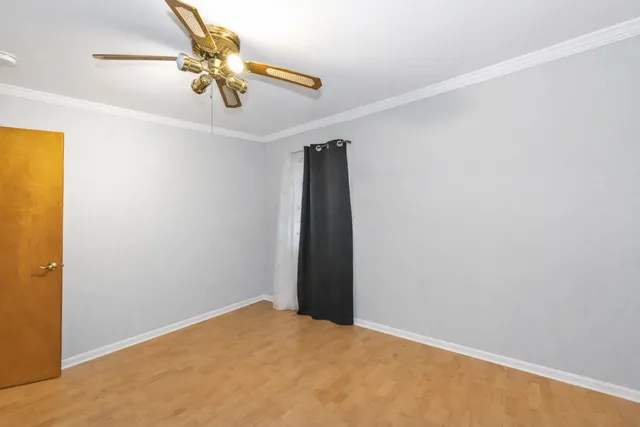 a view of a room with a ceiling fan