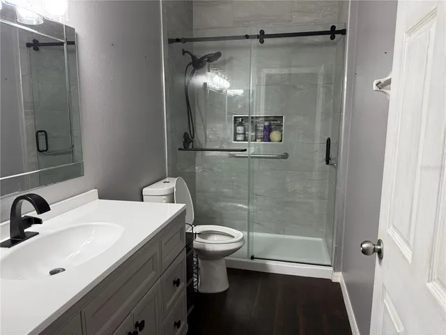 a bathroom with a sink toilet and shower